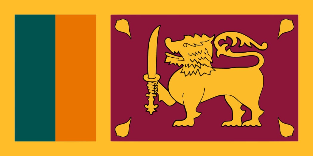 Flag of Sri Lanka with yellow background, green and orange stripes, and lion holding sword